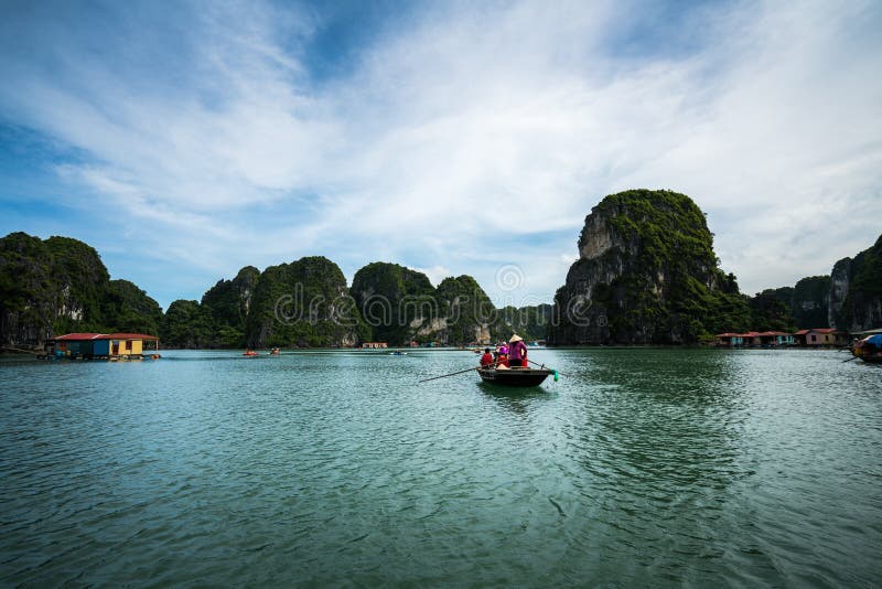 Halong bay in Vietnam, UNESCO World Heritage Site, with tourist rowing boats