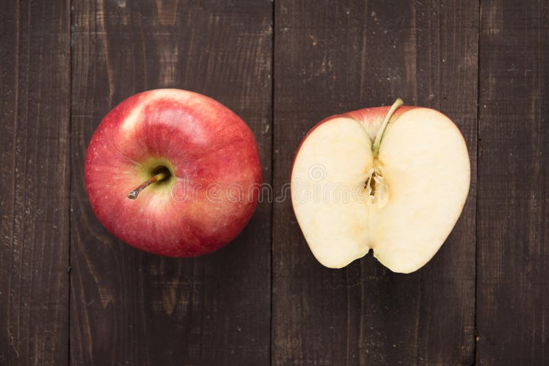 Halve verse rijpe rode appelen op houten achtergrond stock afbeelding Halve verse rijpe rode appelen op houten achtergrond stock afbeelding