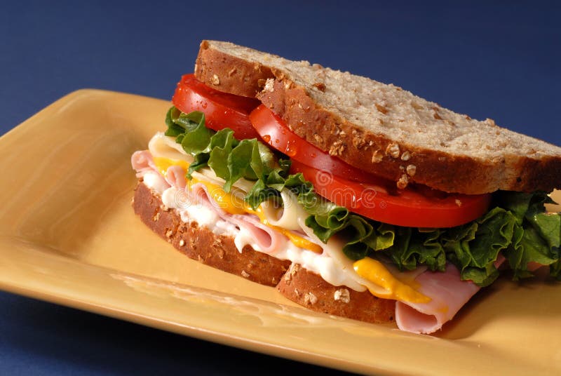 Ham, Cheese, Lettuce and Tomato Sandwich on Yellow Plate Stock Image