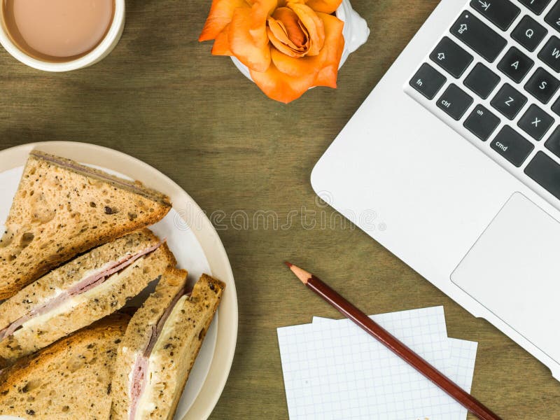 Ham and Cheese Sandwich in Brown Bread with a Cup of Tea Stock Photo