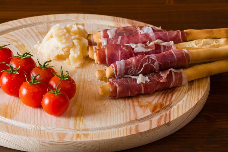 Ham Rolled in Breadsticks Cheese and Cherry Tomatoes Stock Photo