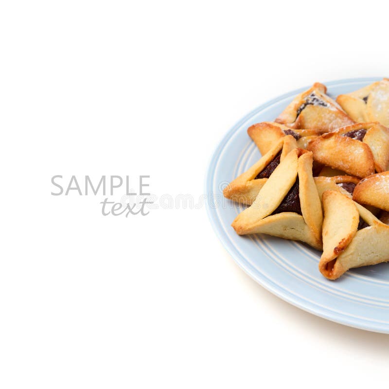 Hamantaschen cookies on plate on white background