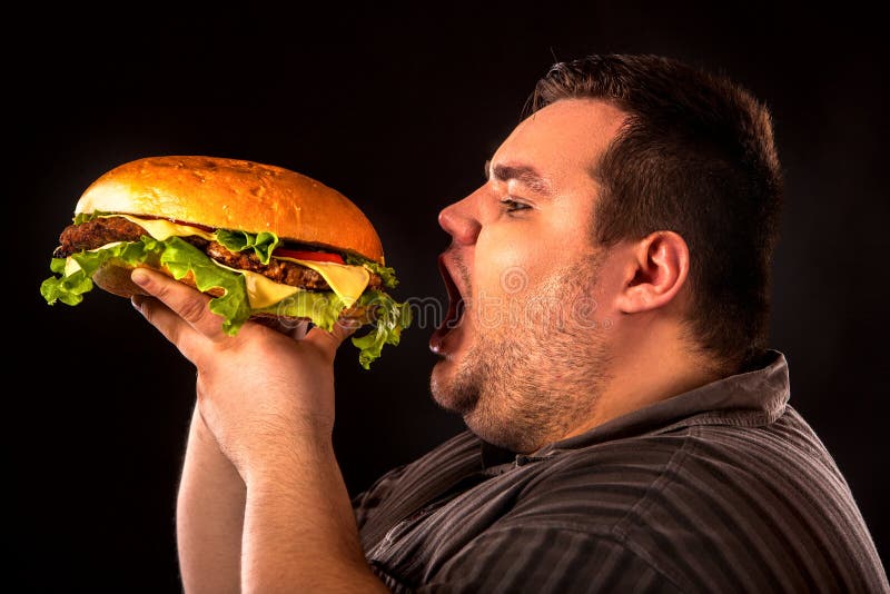Hamberger antropófago gordo de los alimentos de preparación rápida Desayuno para la persona gorda fotografía de archivo Hamberger antropófago gordo de los alimentos de preparación rápida Desayuno para la persona gorda fotografía de archivo