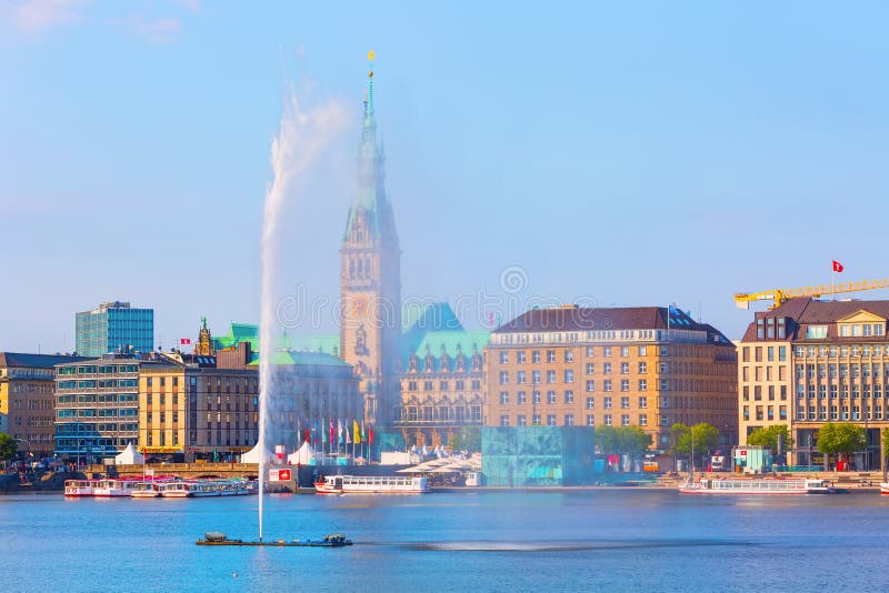 Hamburg Rathaus and Alster lake, Germany. Hamburg, Germany - July 27, 2018: Beautiful view of city center with town hall, fountain and Alster lake stock image Hamburg Rathaus and Alster lake, Germany. Hamburg, Germany - July 27, 2018: Beautiful view of city center with town hall, fountain and Alster lake stock image