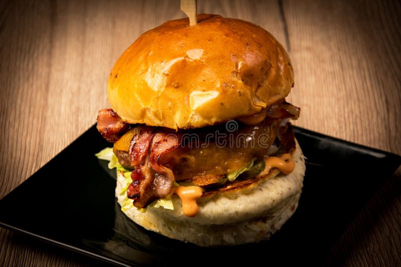 Hamburger with bacon stock image. Image of restaurant - 121940343