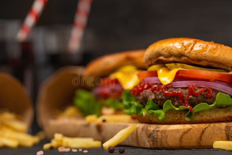 Hamburger or burger with french fries and soda on black background