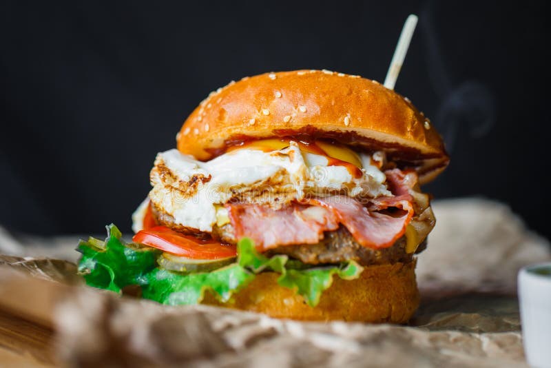 Hamburger with Egg Beef and Vegetables on a Grey Ceramic Plate. Stock