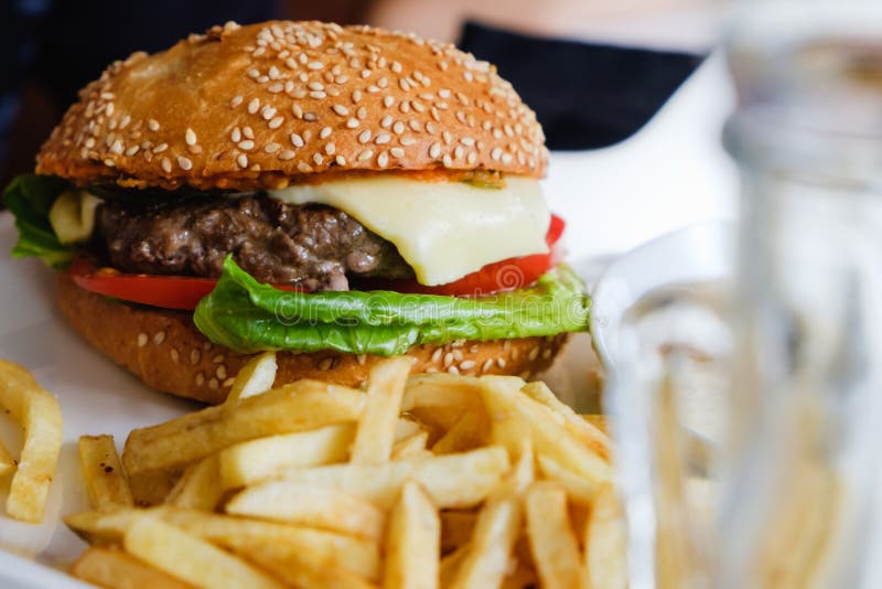 Hamburger and French Fries in White Plate, Bitten Off Stock Photo ...