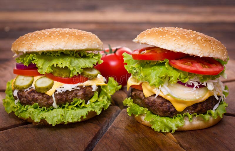 Fast food - fresh hamburgers on the table close up. Fast food - fresh hamburgers on the table close up