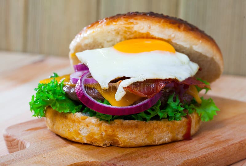 Hamburger with with Fried Egg, Beef, Onion, Cheese and Lettuce Stock