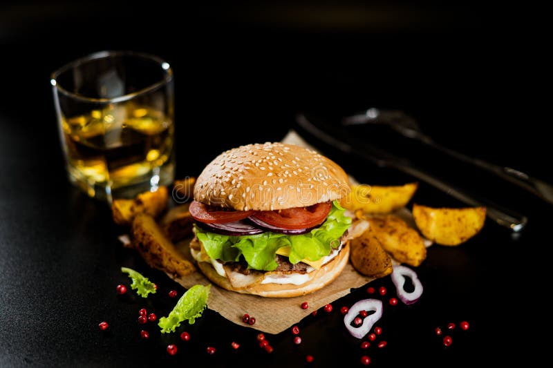 Hamburger with Meat Patty and Cheese. Bacon and Fresh Vegetables Stock