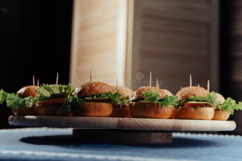 Hamburger on wood table. Home made burger. Fastfood meal. Beef, american.