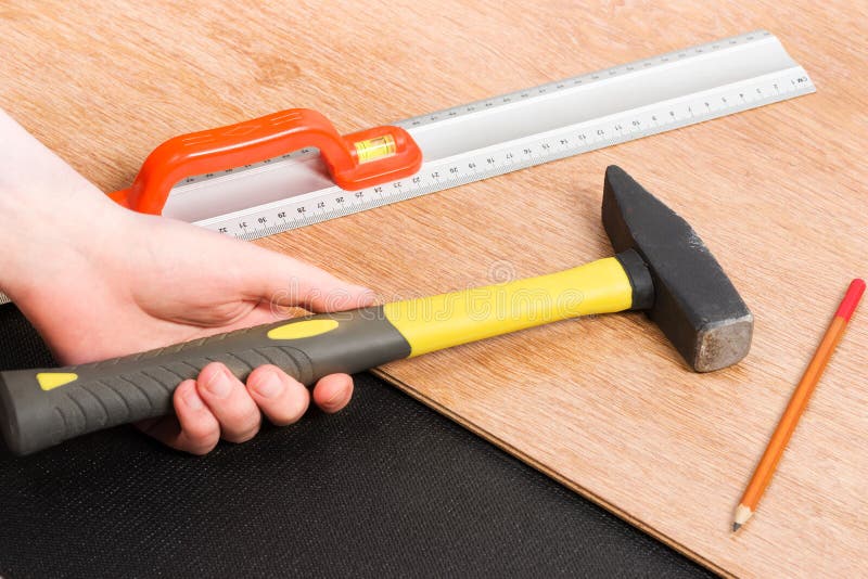 Hammer, Laminate Flooring And New Baseboard Molding Stock Image Image