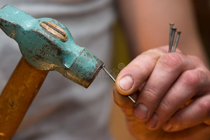 Hammer in a nail stock photo. Image of skilled, building 11469470