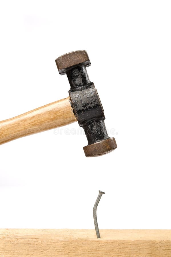 Old hammer hitting a nail stock photo. Image of nail 214039004