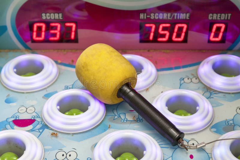 Hammer on a Whac-A-Mole arcade game