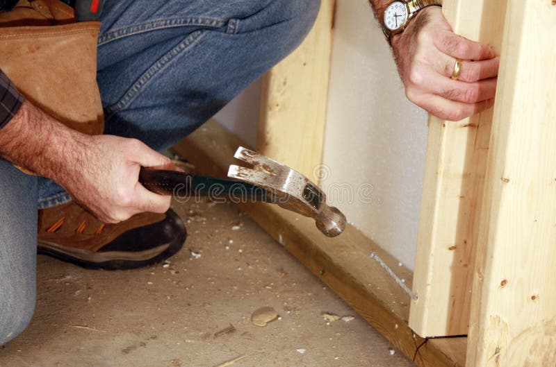Close Up Of Man With Hammer Hammering Nail In Wall Stock Photo Image