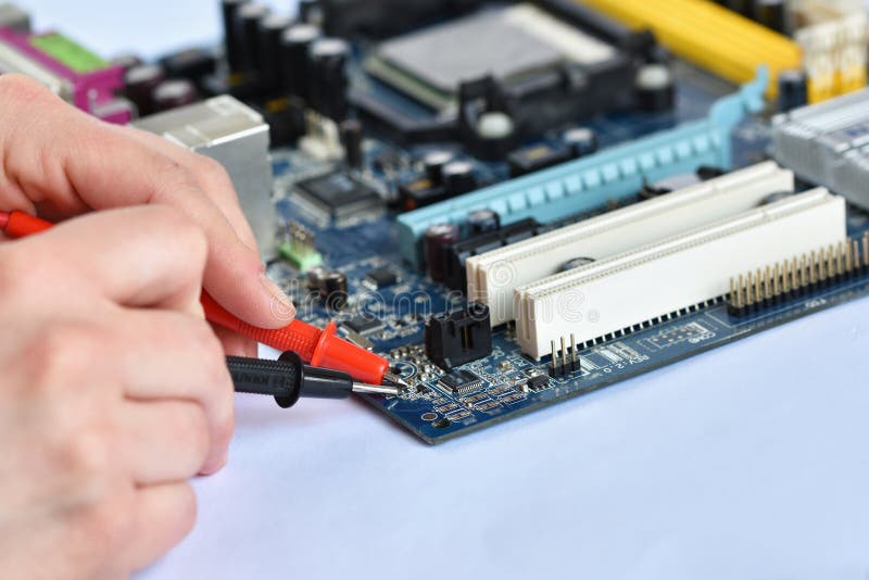 Hand above board with components. Repair of computers and modern technologies.