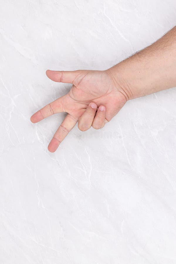 hand above white background with three fingers sign