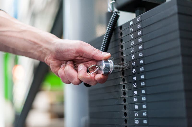 Hand adjusting weights in fitness center royalty free stock image Hand adjusting weights in fitness center royalty free stock image