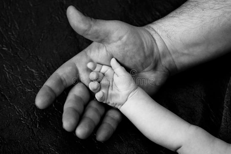 Hand of an adult and child stock image