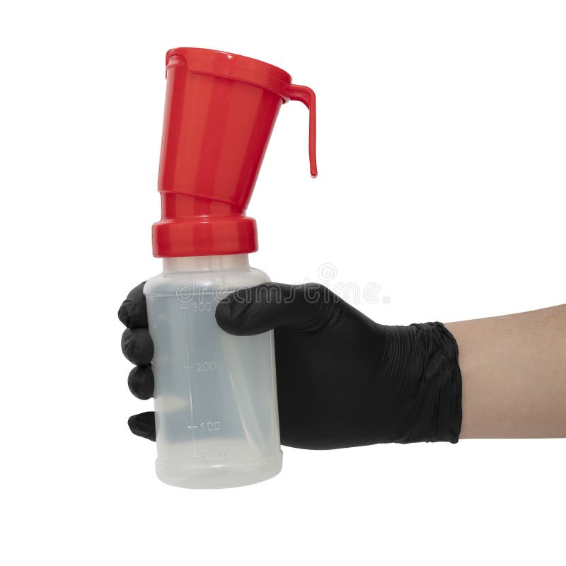 Hand in black nitrile glove holds a teat dip cup for udder cow disinfection, isolated