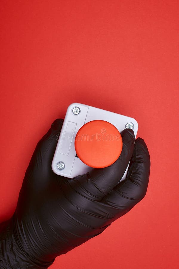 The Hand in Black Resin Glove, Which Constrict the Emergency Button at