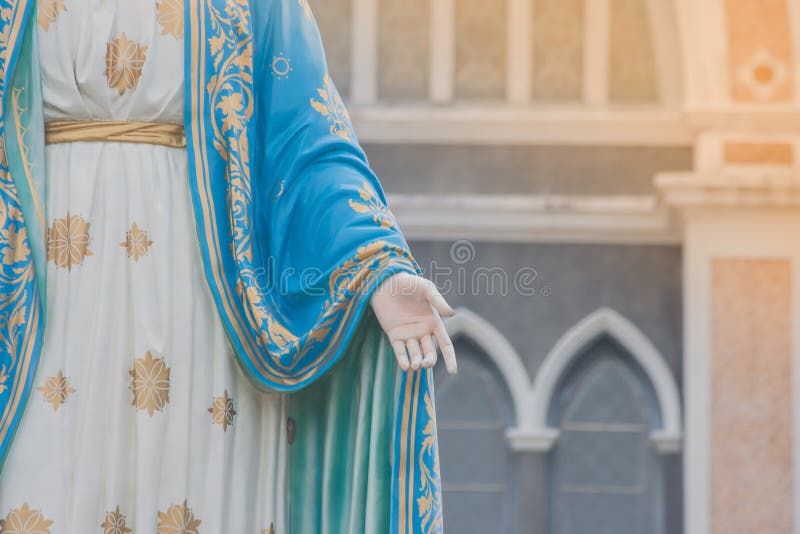 Hand of The Blessed Virgin Mary statue standing in front of The Roman Catholic Diocese.