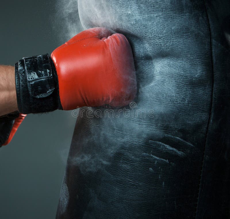 Hand of boxer and punching bag over black royalty free stock photography Hand of boxer and punching bag over black royalty free stock photography