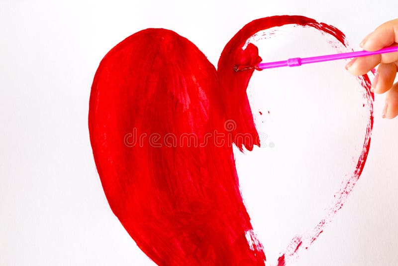 Hand with Brush Drawing Shape of Heart Isolated on White Stock Image