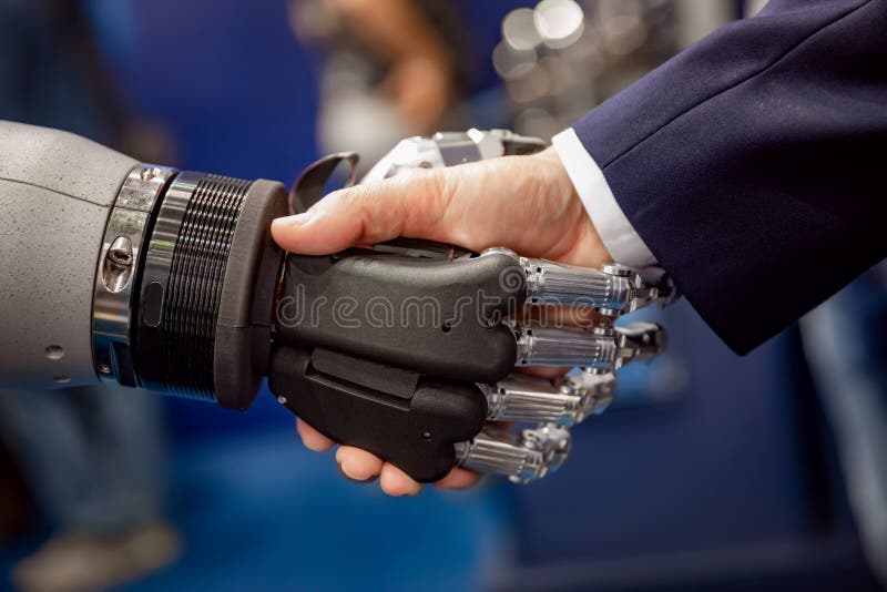 Hand of a businessman shaking hands with a Android robot. stock photos