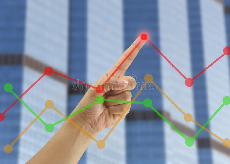 Hand of businessmen point to the highest point on the line graph in concept of business profits in the presentation.