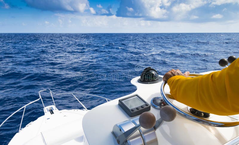 Hand of captain on steering wheel of motor boat in the blue ocean during the fishery day. Success fishing concept. Ocean yacht. stock photography Hand of captain on steering wheel of motor boat in the blue ocean during the fishery day. Success fishing concept. Ocean yacht. stock photography