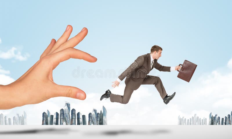 Hand catching businessman running forward royalty free stock photography