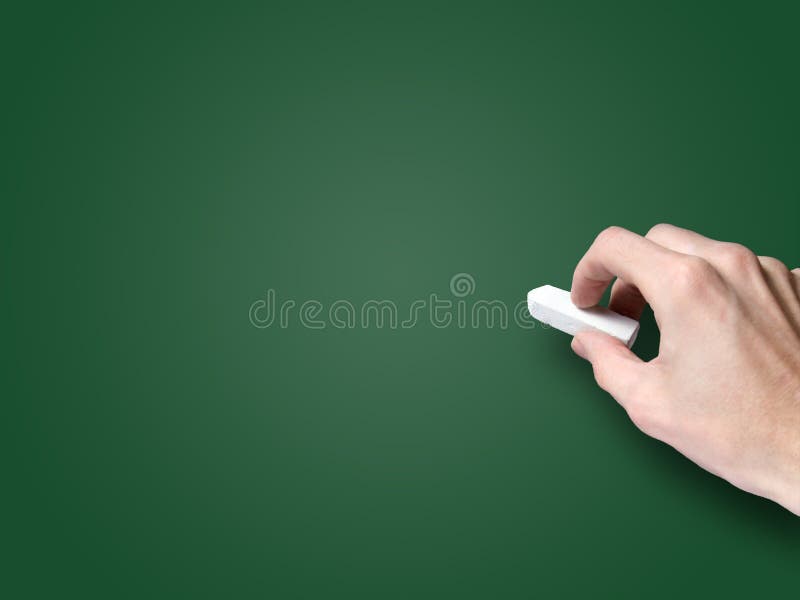 Hand with chalk on blank blackboard