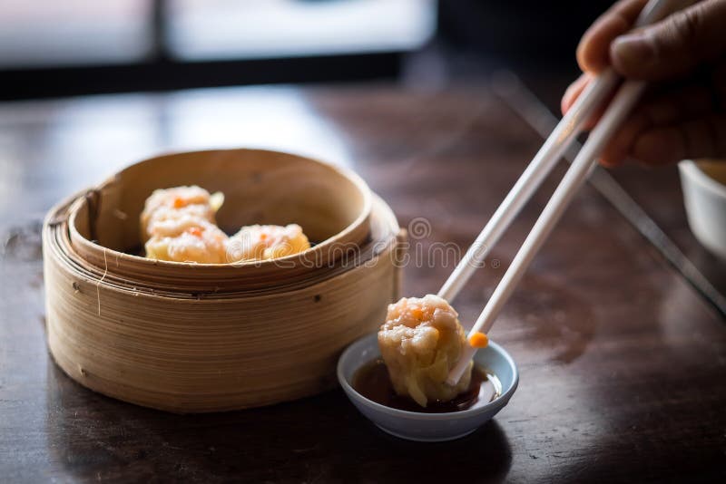 Chinese steamed shrimp dimsum in bamboo containers with soy sauce. Chinese steamed shrimp dimsum in bamboo containers with soy sauce