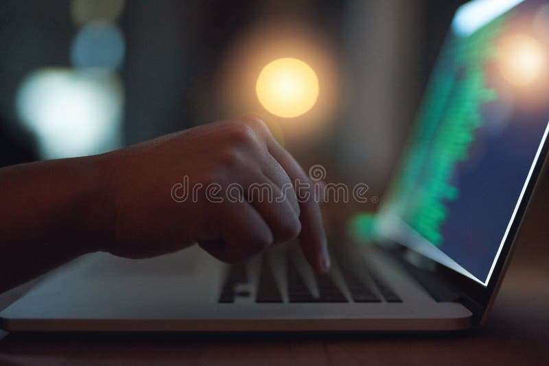 Hand, coding and hacker on laptop at night as malware thief for hacking database software, hardware virus or firewall royalty free stock photo