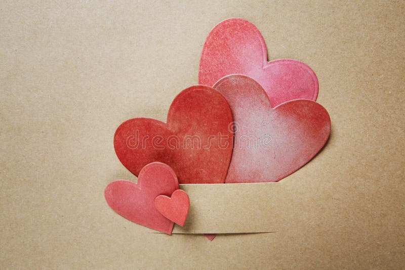 Hand-crafted paper hearts on earthy colored paper