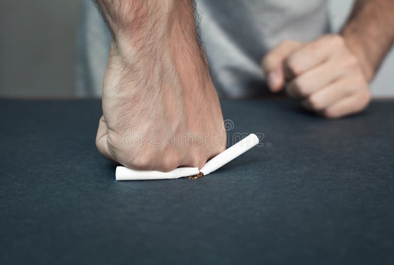 Hand crushing cigarette. stock image. Image of habit 113302405