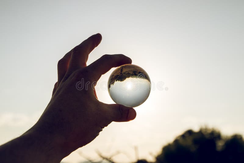 A hand with a crystal ball stock image. Image of hand 127376729