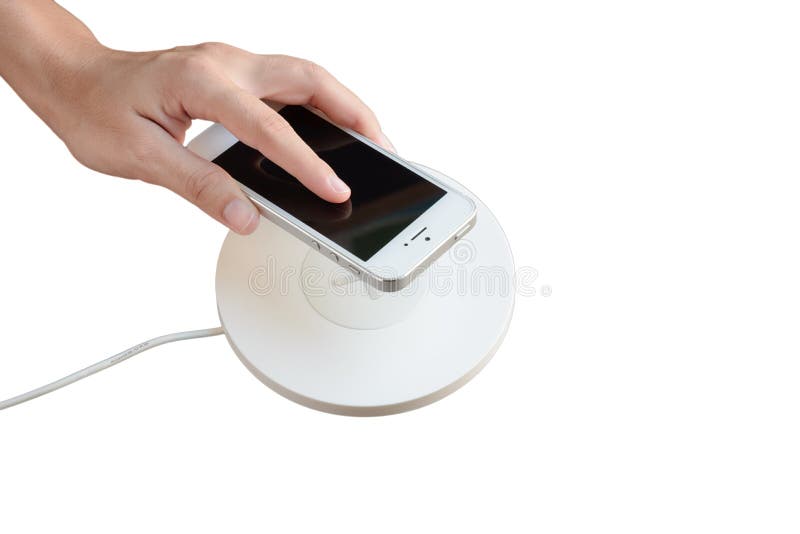 Hand die mobiele telefoon op draadloze lader, modern materiaal zetten, royalty-vrije stock fotografie Hand die mobiele telefoon op draadloze lader, modern materiaal zetten, royalty-vrije stock fotografie