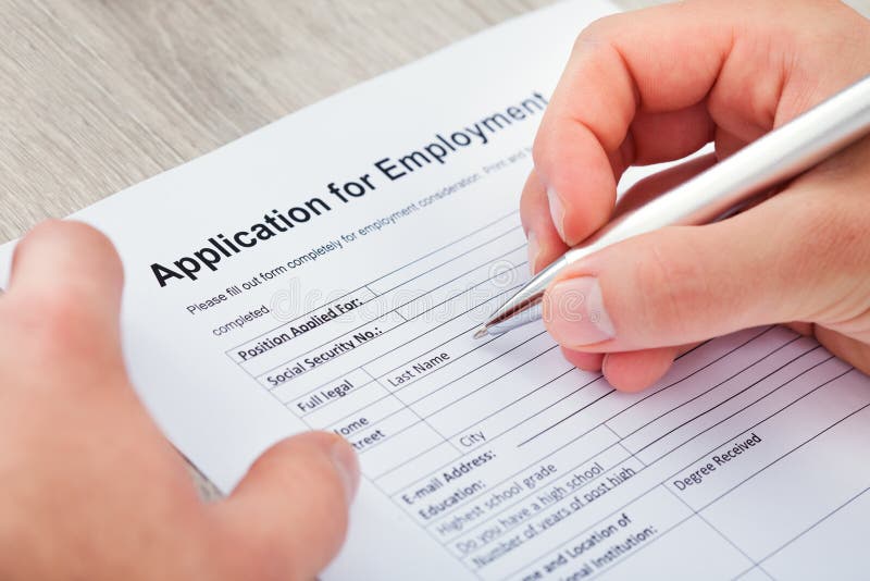 Hand filling application for employment stock photos