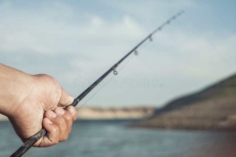 Hand with fishing Pole stock photo. Image of outdoor 43733760