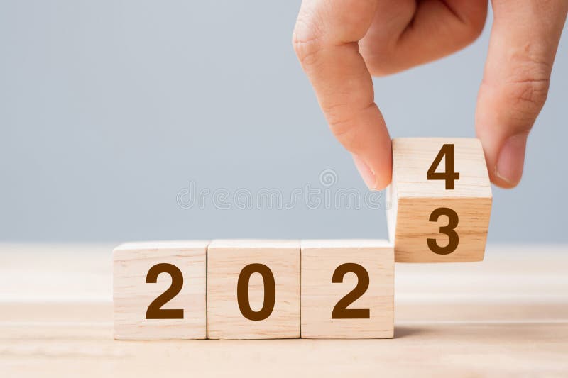 2024 Review New Year Symbol. Businessman Turns a Wooden Cube and