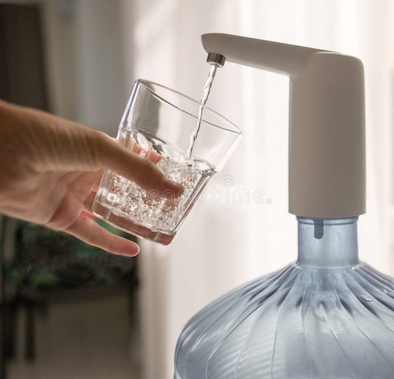 Hand with a Glass Pours Water from the Cooler Stock Photo Image of