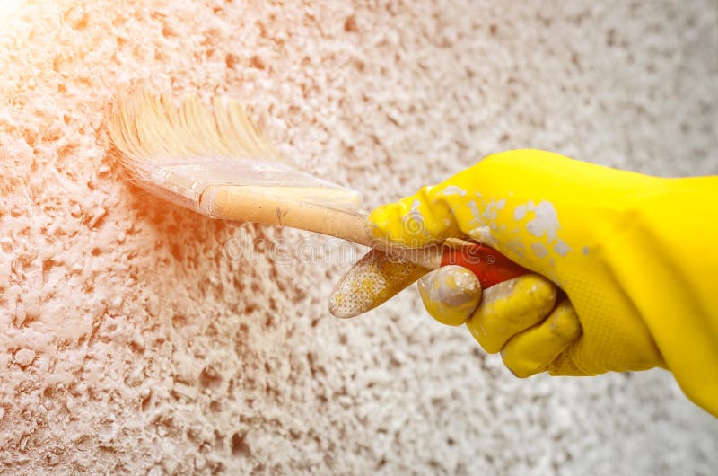 Hand in Glove with a Paint Brush Painting on Wall Stock Photo Image