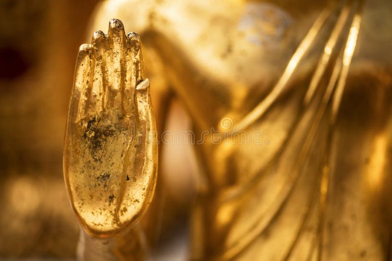 Hand of a golden Monday Buddha statue