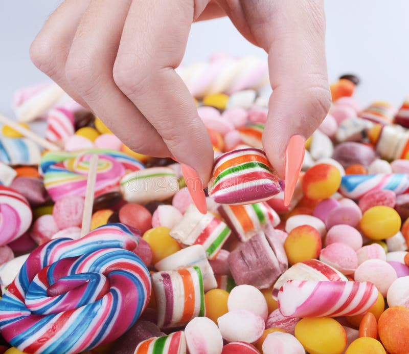 Hand Grabbing Candy from Pile Overweight Problem Concept Stock Image