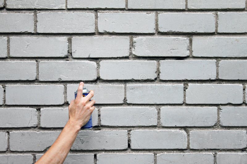 Hand with Graffiti Spray Can in Front of Brick Wall Stock Photo Image