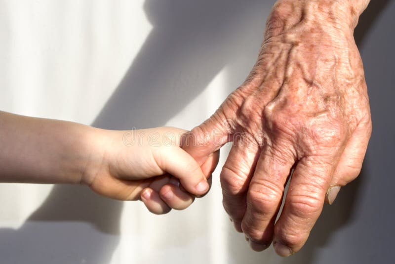 Hand of grandmother and grandchild